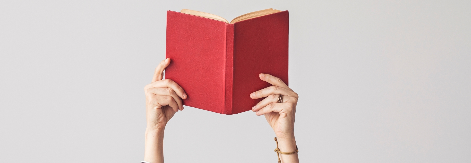 The hand holding book on isolated background
